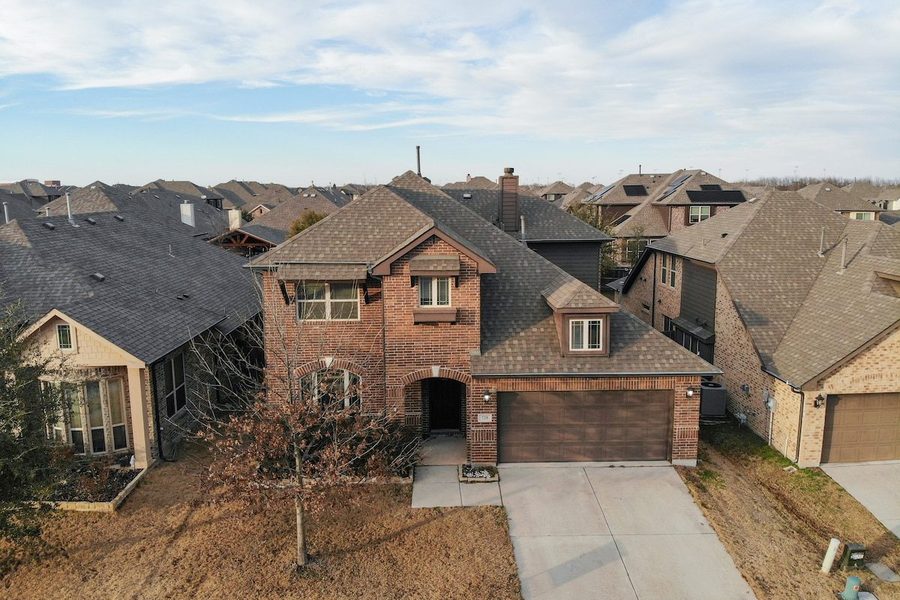 Two-storey red-brick executive home with an attached garage in Anna, Texas