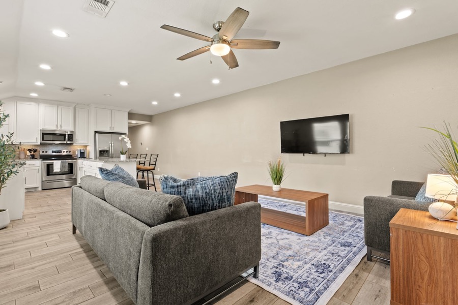 Living room with blue accent chairs and dark hardwood floors in Sherman, Texas